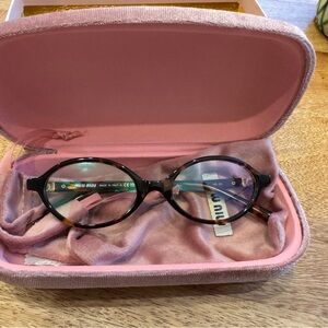 Miu Miu Women's Tortoiseshell Oval Glasses in Brown and Black